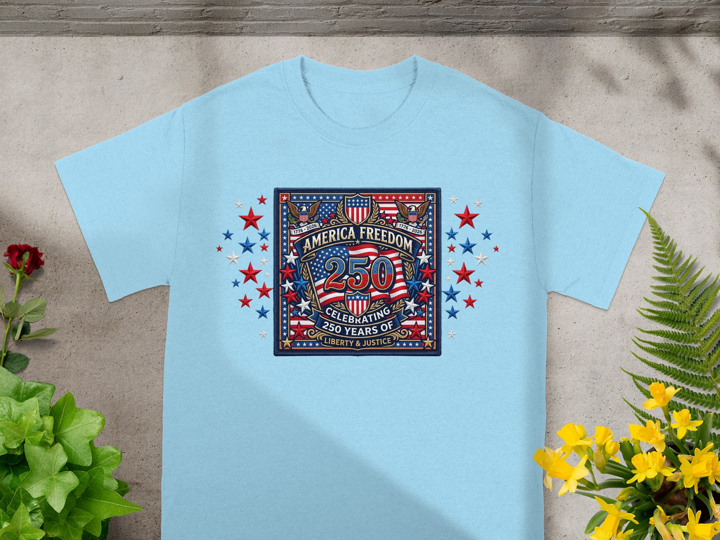 Light blue t-shirt with "America Freedom 250" emblem celebrating 250 years of liberty and justice.