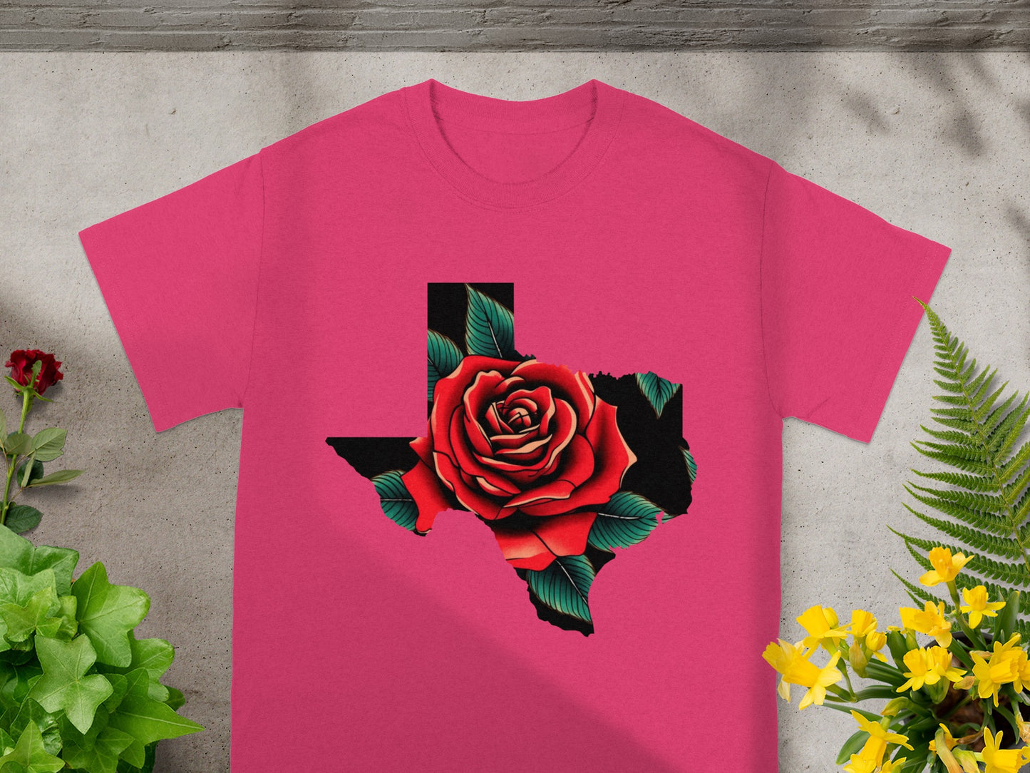 Pink t-shirt with a red rose inside the outline of Texas.