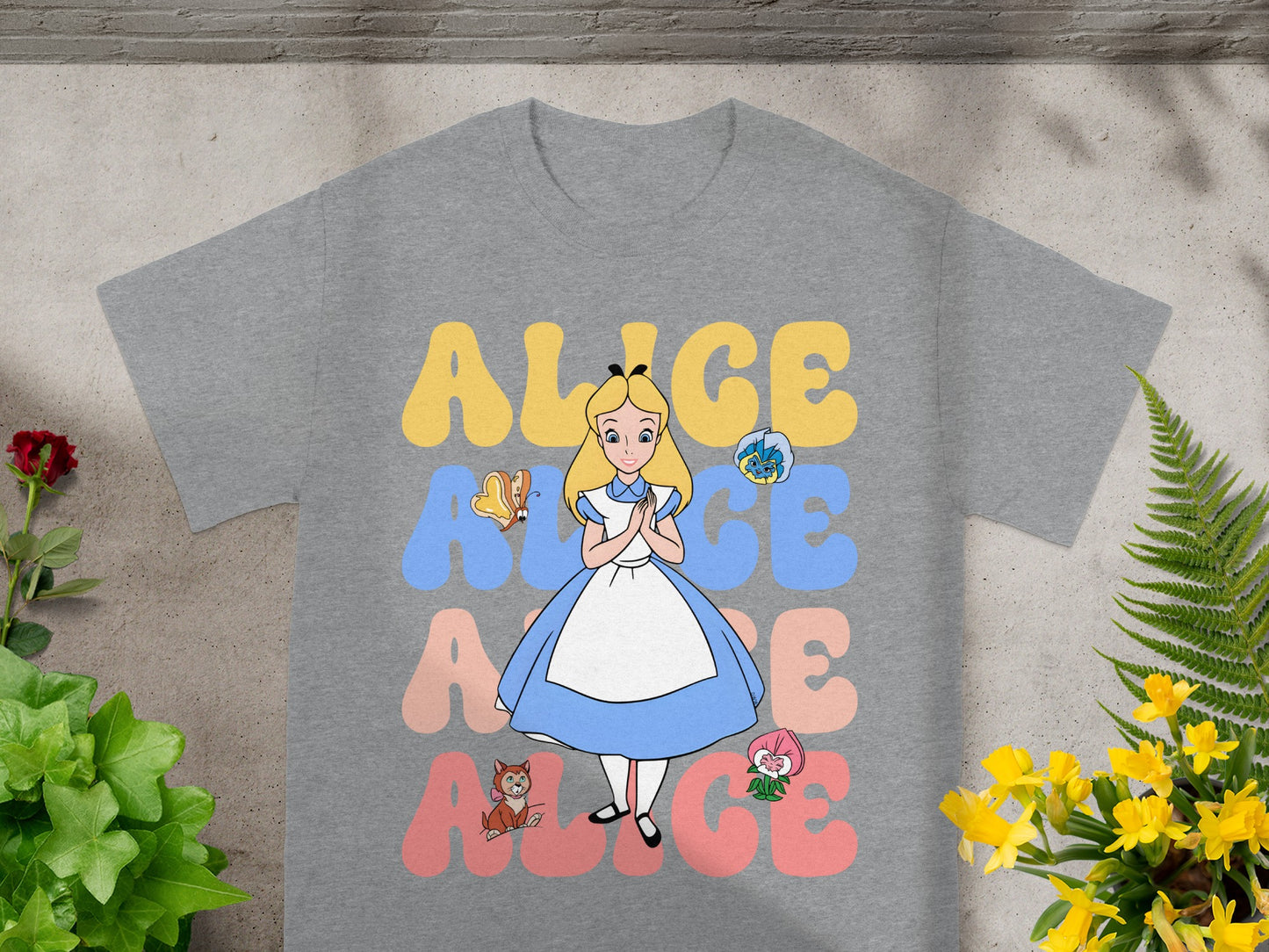 Alice with characters and text "ALICE" on a gray t-shirt.