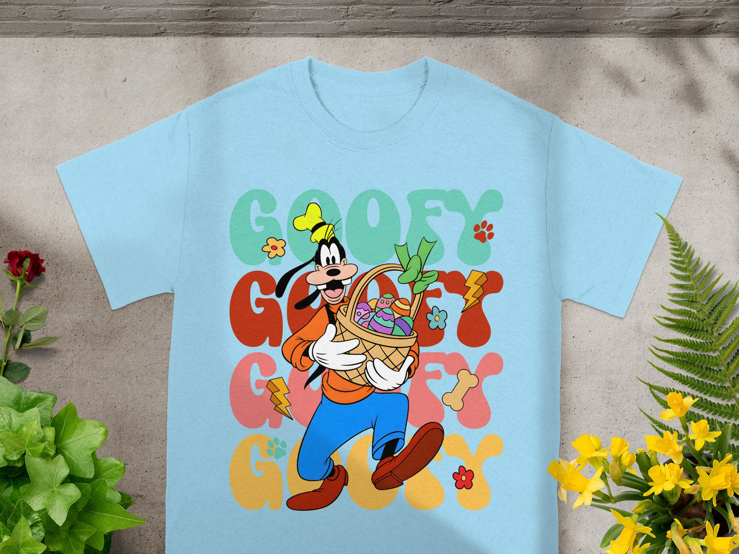 Goofy in a colorful Easter graphic on a light blue t-shirt.