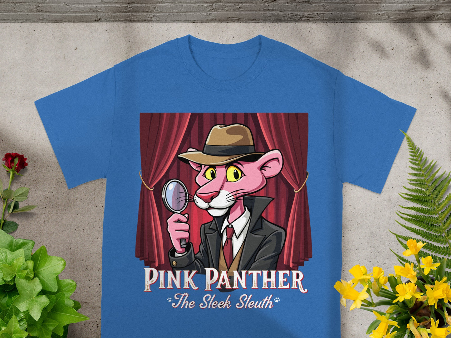 Pink Panther "The Sleek Sleuth" graphic on a blue t-shirt with red curtains.