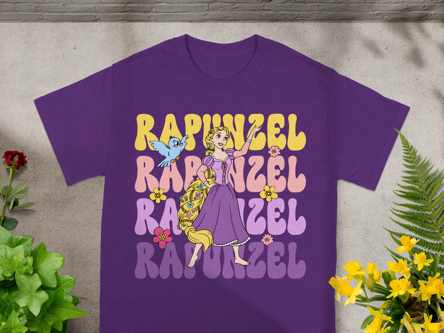 Purple t-shirt with Rapunzel and Pascal graphic and text.