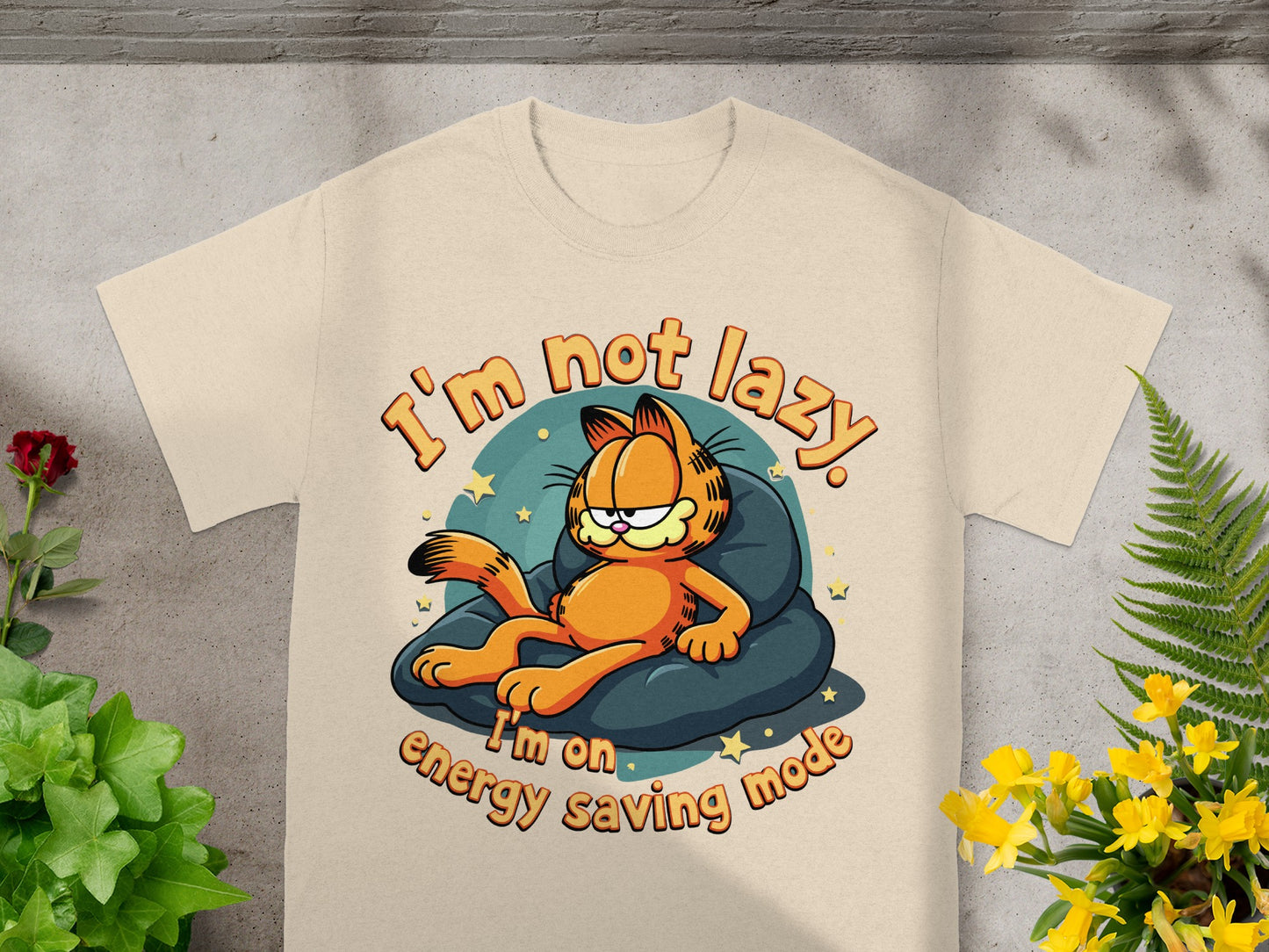 Garfield the cat on a pillow, text "I'm not lazy. I'm on energy saving mode."