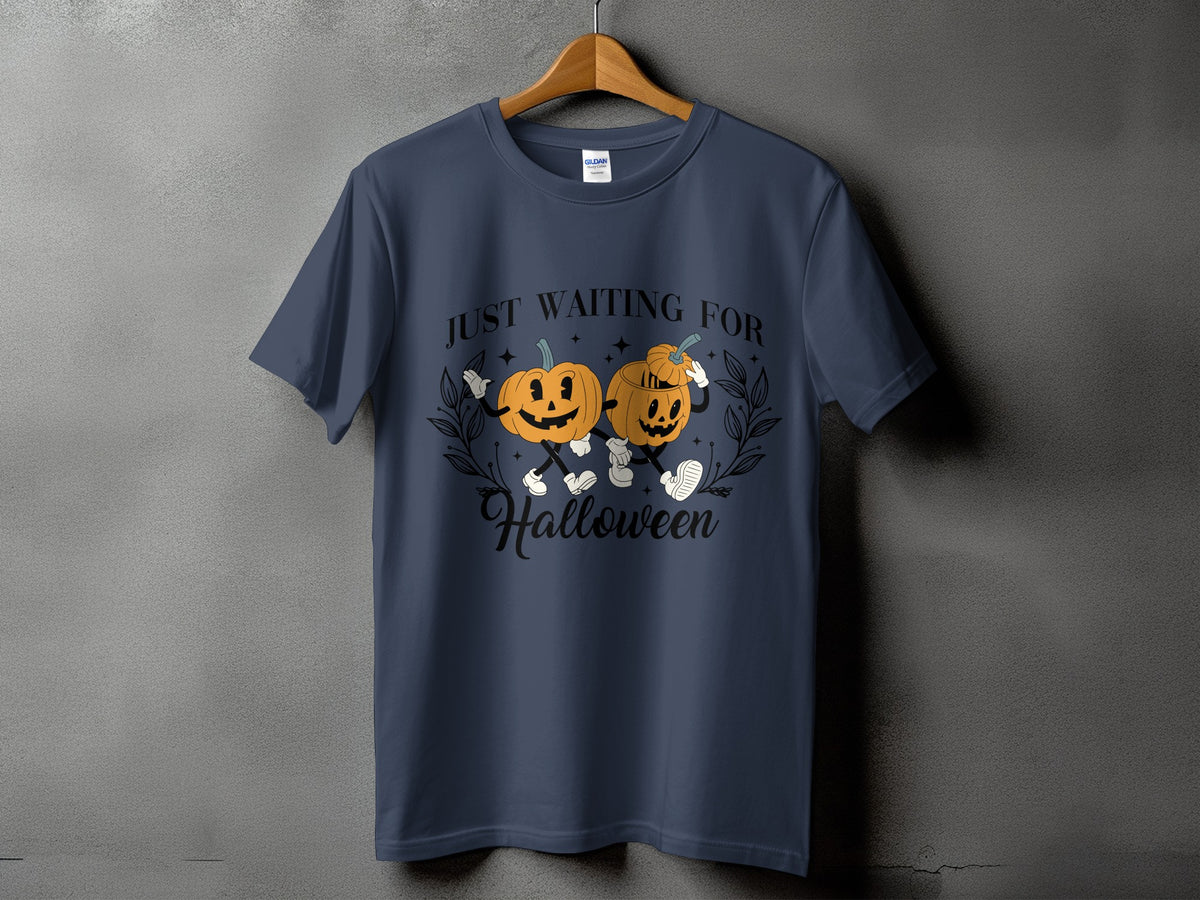 Dark blue t-shirt with two cartoon pumpkins saying "Just Waiting For Halloween".