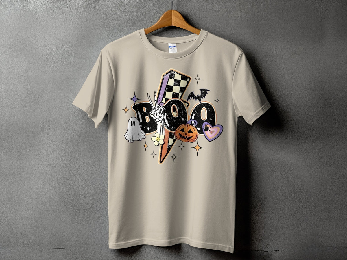 Tan t-shirt with "BOO" text and Halloween graphics like a ghost, pumpkin, and bat.