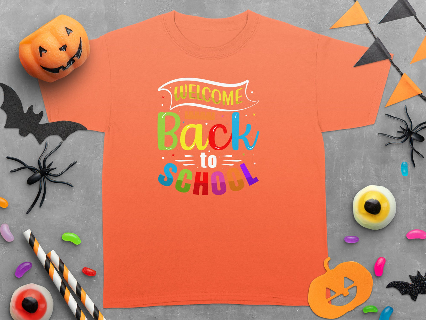 Orange t-shirt with "Welcome Back to School" text and Halloween decorations.