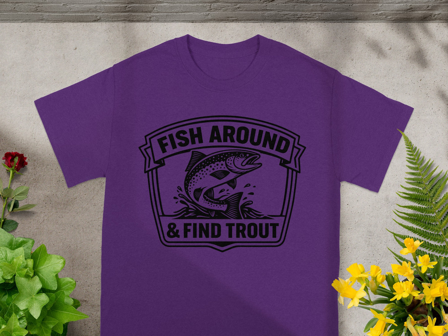 Purple t-shirt with black graphic: "FISH AROUND & FIND TROUT" and jumping trout.