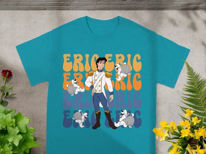 Prince Eric with dogs on a teal t-shirt with orange and yellow text.