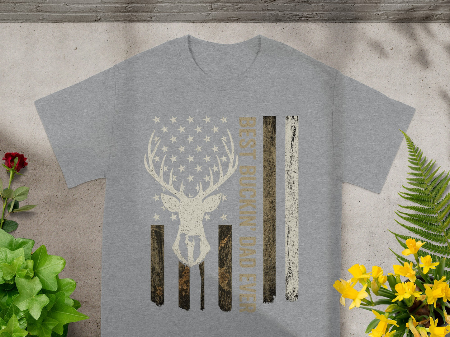 Gray t-shirt with deer silhouette and American flag design reading "BEST BUCKIN' DAD EVER".