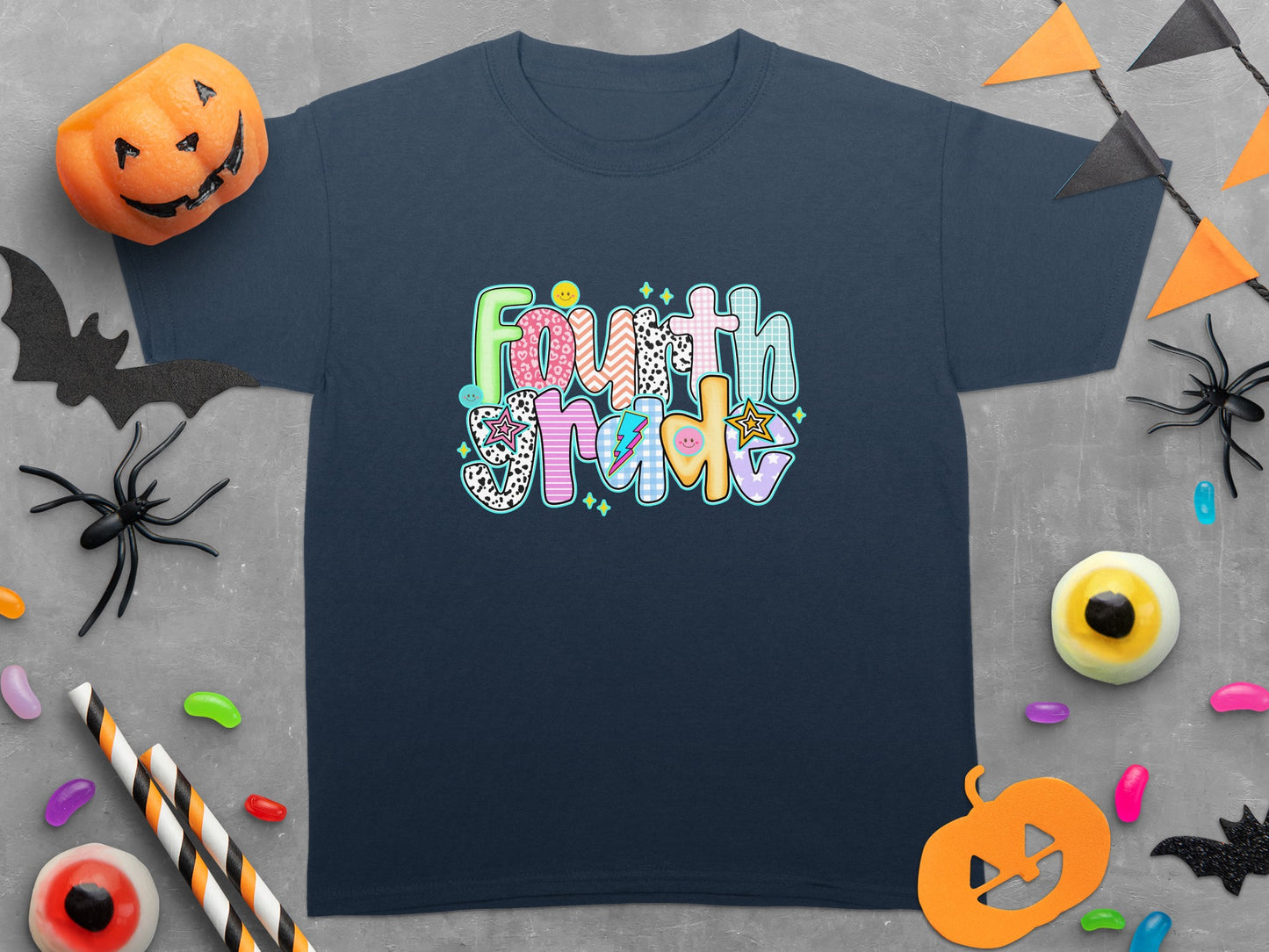 Navy t-shirt with text Fourth Grade surrounded by Halloween decorations.