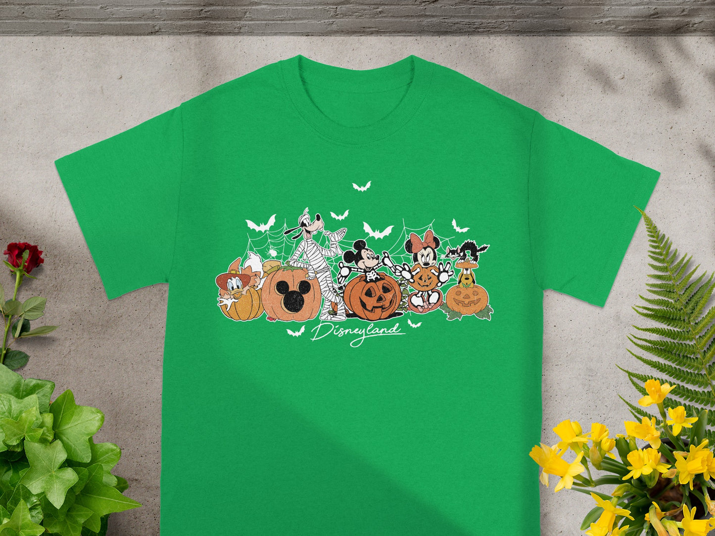 Green t-shirt with Disney characters dressed for Halloween and "Disneyland" text.