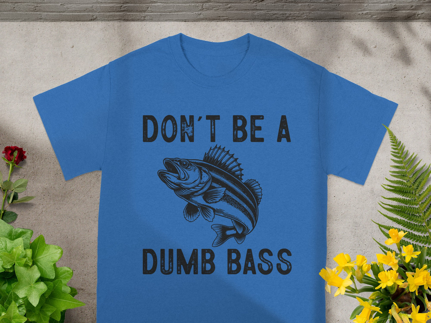 Blue t-shirt with black text "DON'T BE A DUMB BASS" and a fish graphic.