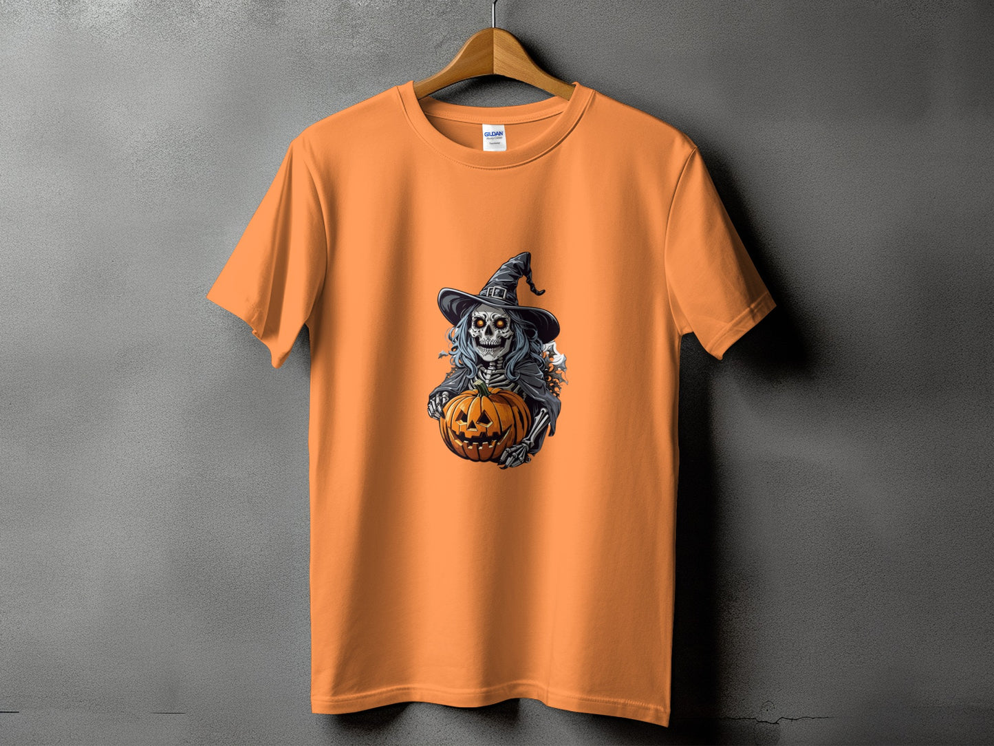Orange t-shirt with Halloween skeleton holding a jack-o'-lantern graphic.