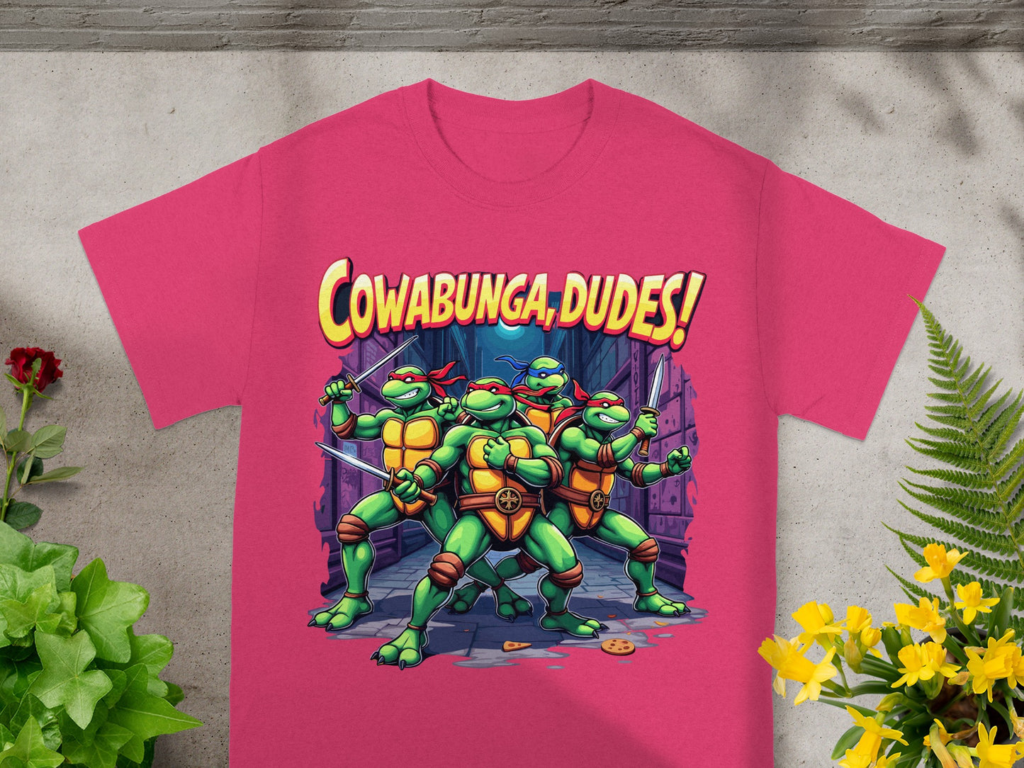 Teenage Mutant Ninja Turtles with sword, text "Cowabunga, Dudes!" on pink shirt.