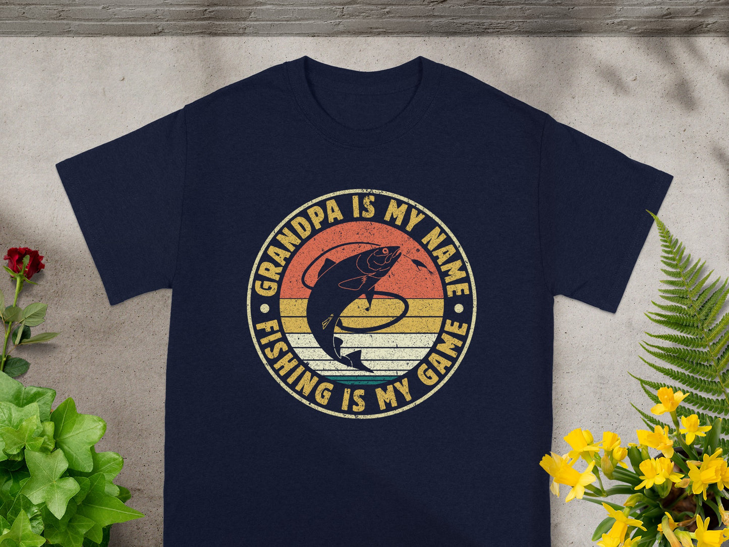 Navy t-shirt with circular graphic: "Grandpa is my name, Fishing is my game".