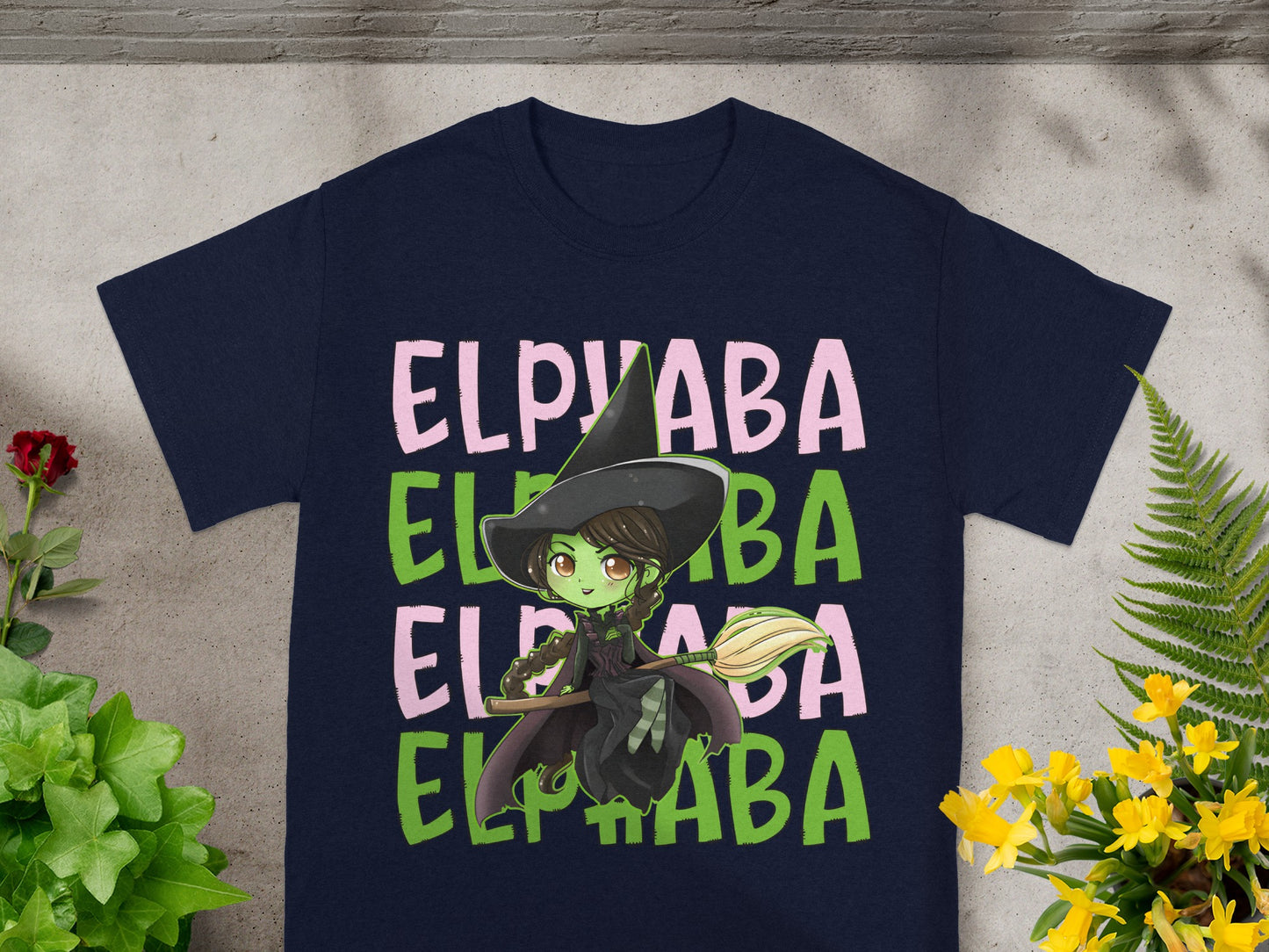Navy t-shirt with "Elphaba" text and a cartoon witch on a broomstick.