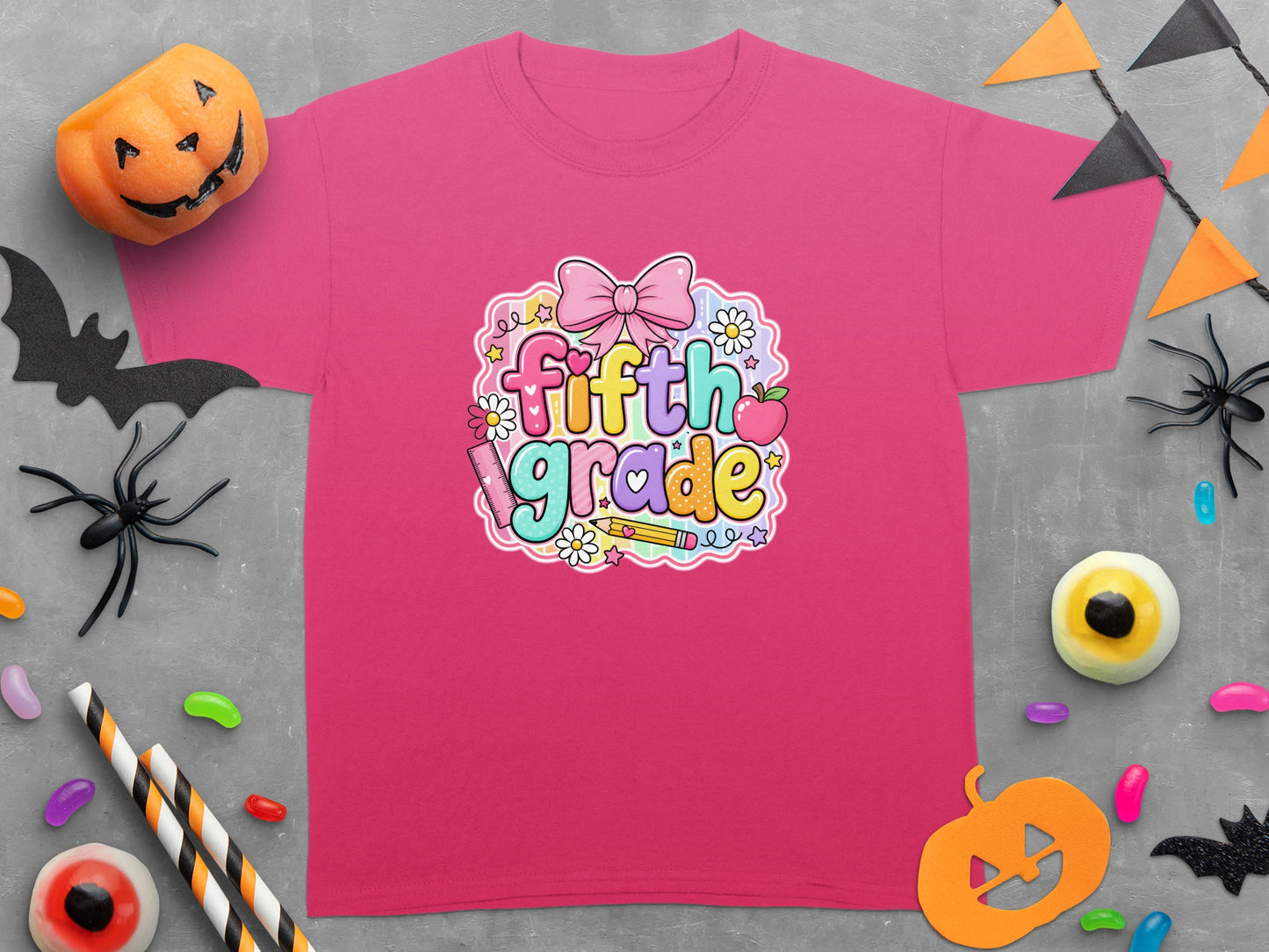 Pink t-shirt with "fifth grade" text surrounded by school and Halloween motifs.