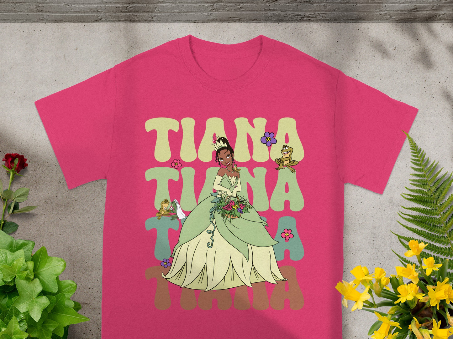 Princess Tiana in a green gown with flowers and Naveen as a frog.
