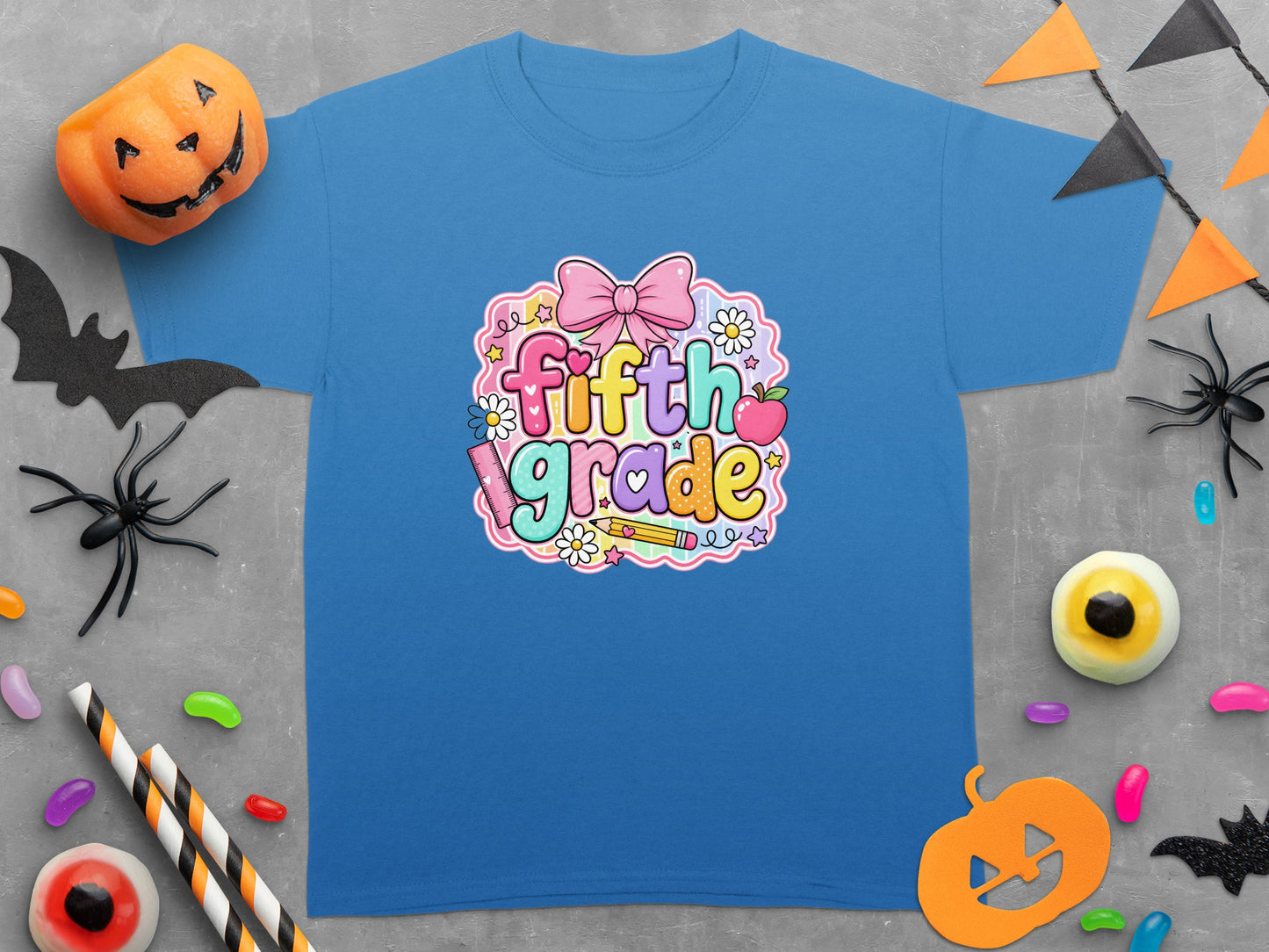 Blue t-shirt with "fifth grade" text and Halloween decorations.