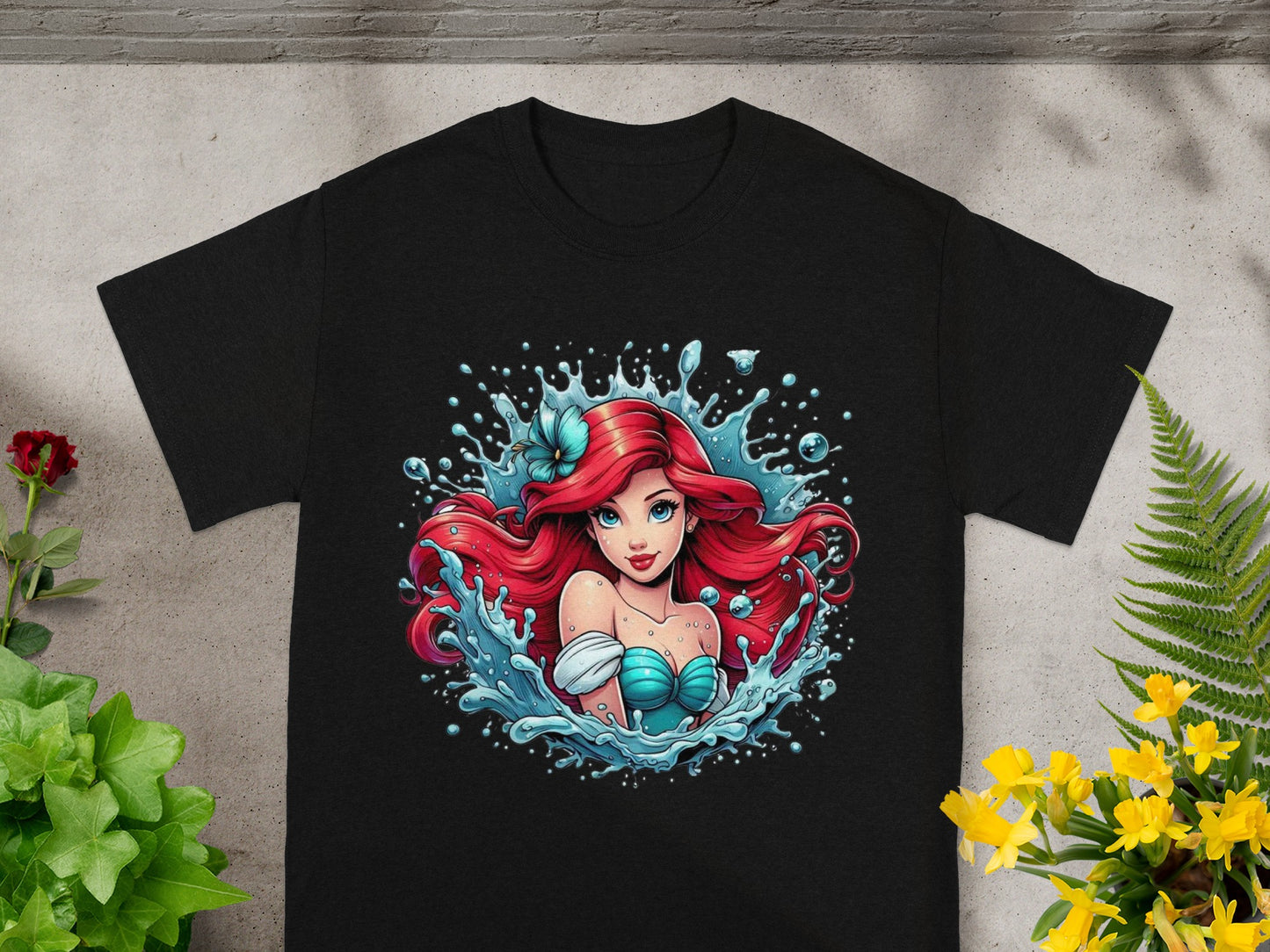Black t-shirt featuring Ariel from The Little Mermaid with water splashes.