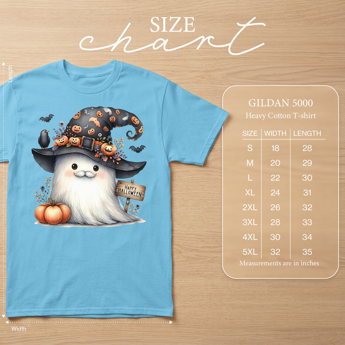 Blue t-shirt with a watercolor ghost wearing a witch hat, holding a pumpkin. Includes size chart.