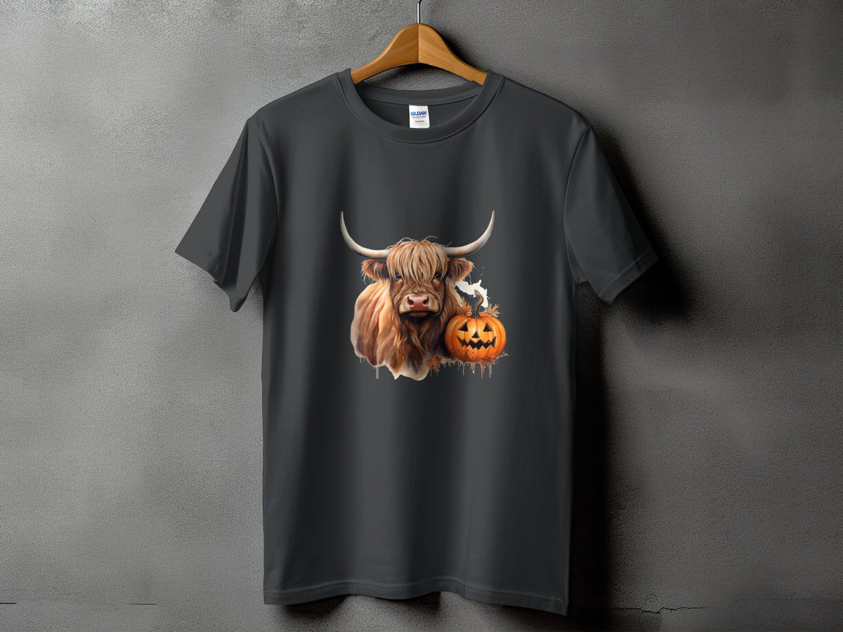Highland cow with pumpkin and ghost graphic on a dark grey t-shirt.