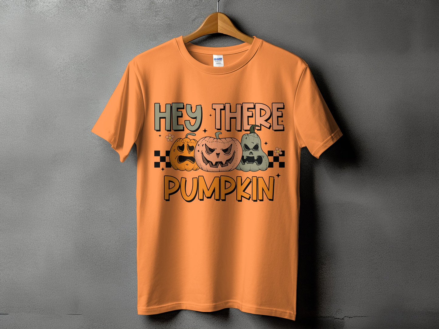 Orange t-shirt with "Hey There Pumpkin" graphic and three jack-o'-lanterns.