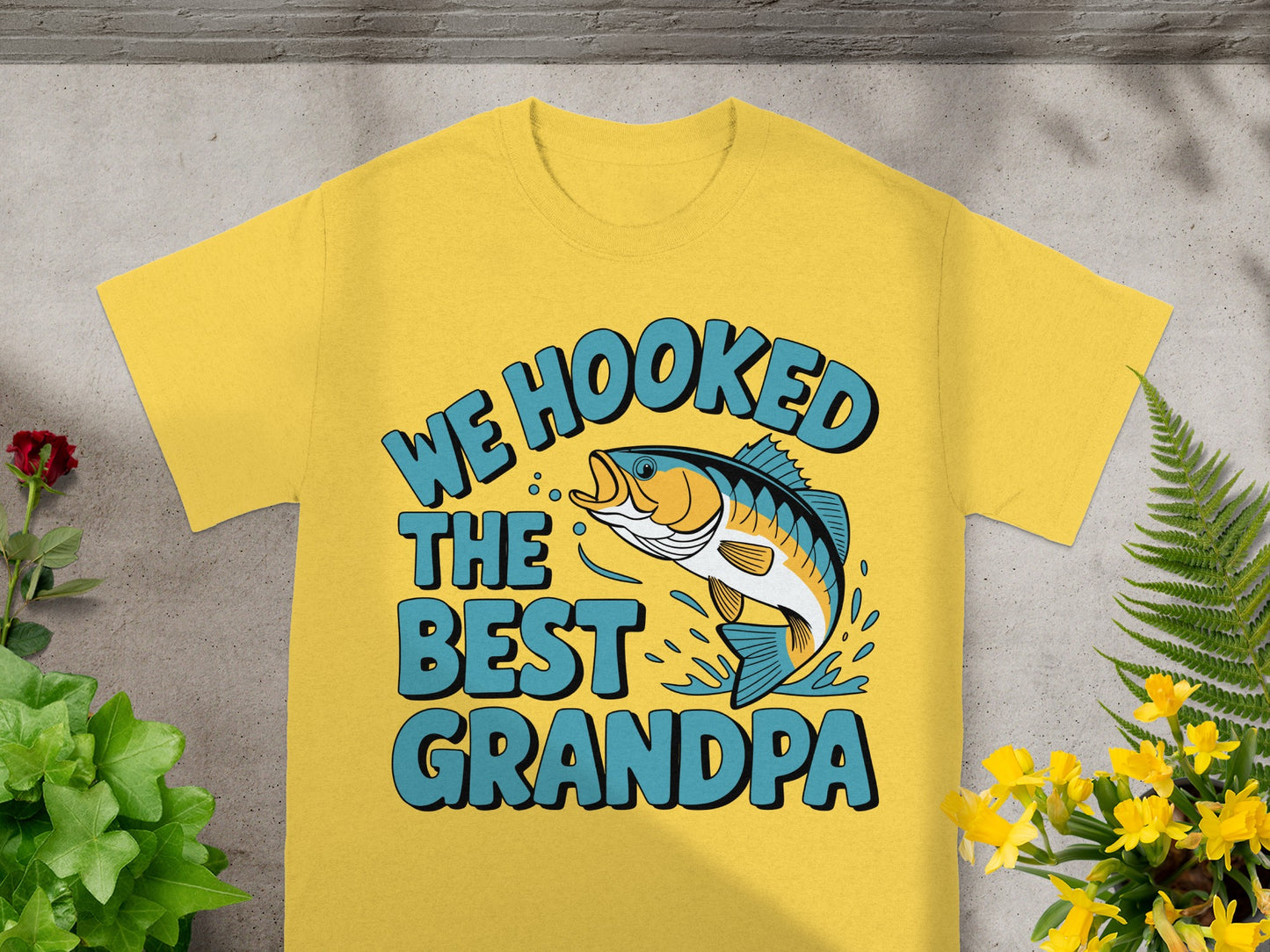 Yellow t-shirt with "We Hooked The Best Grandpa" and a leaping fish.