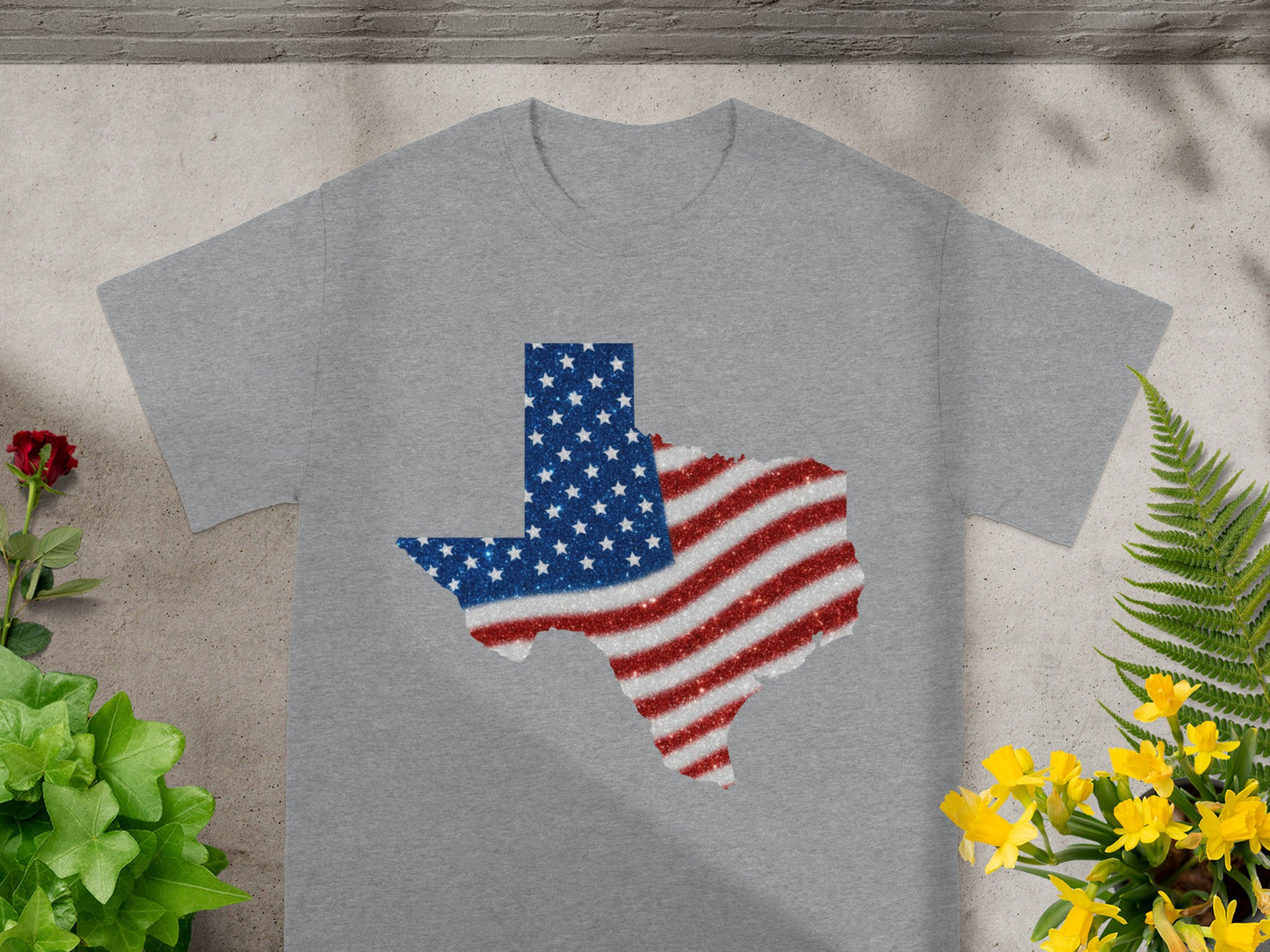 Grey t-shirt with a glittery Texas outline filled with the American flag design.