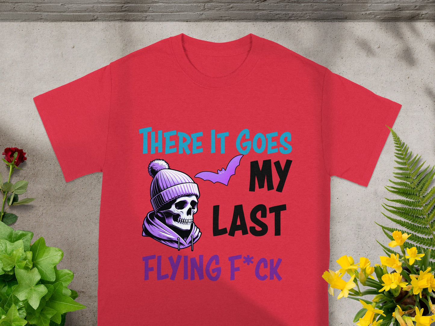Red t-shirt with skull, bat, and text "THERE IT GOES MY LAST FLYING F*CK".