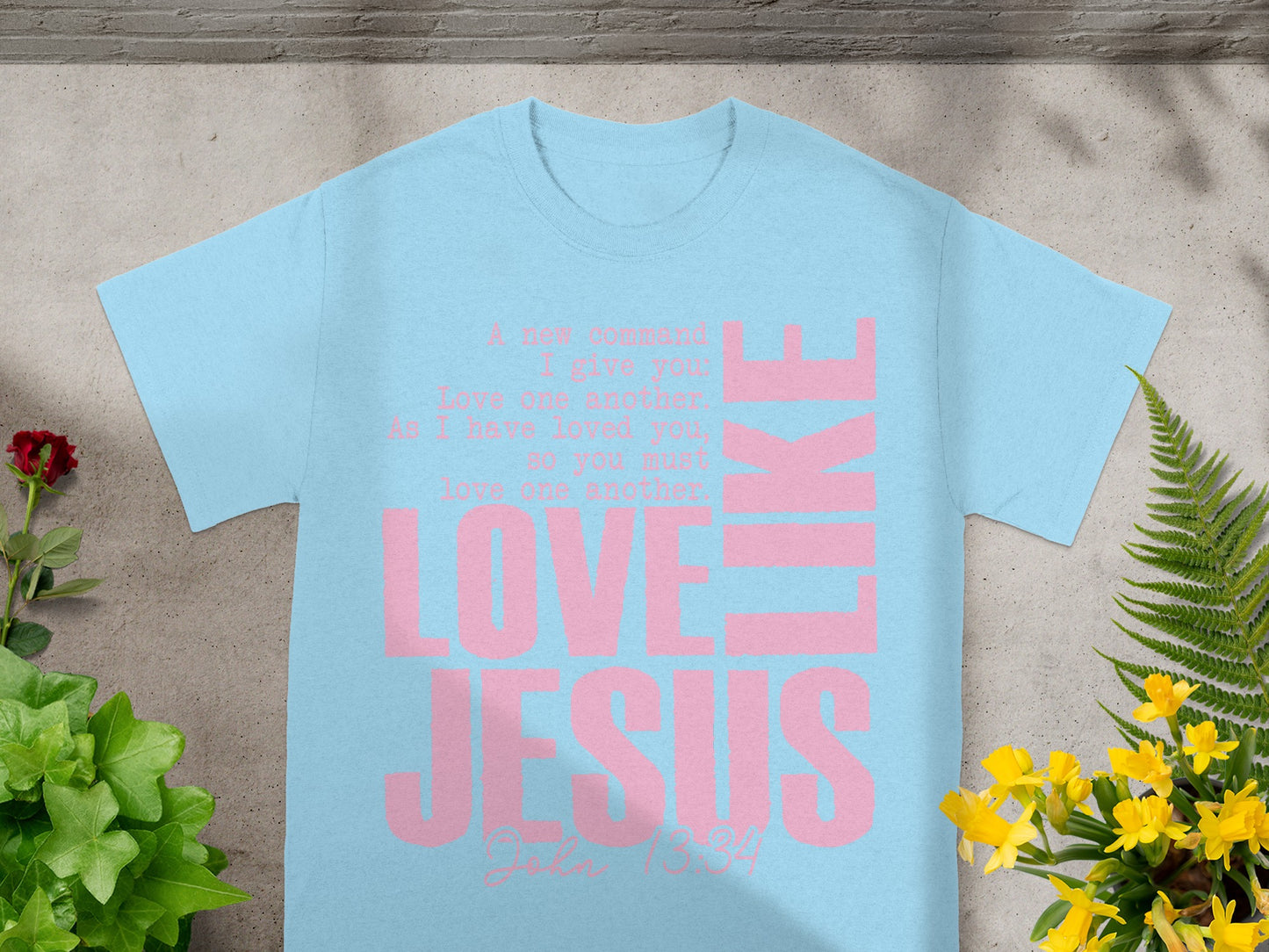 Light blue t-shirt with pink text "LOVE JESUS LIKE"
