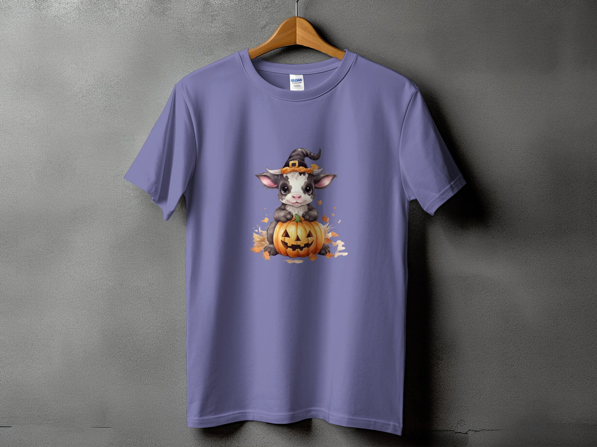 Purple t-shirt with a baby cow wearing a witch hat on a pumpkin.