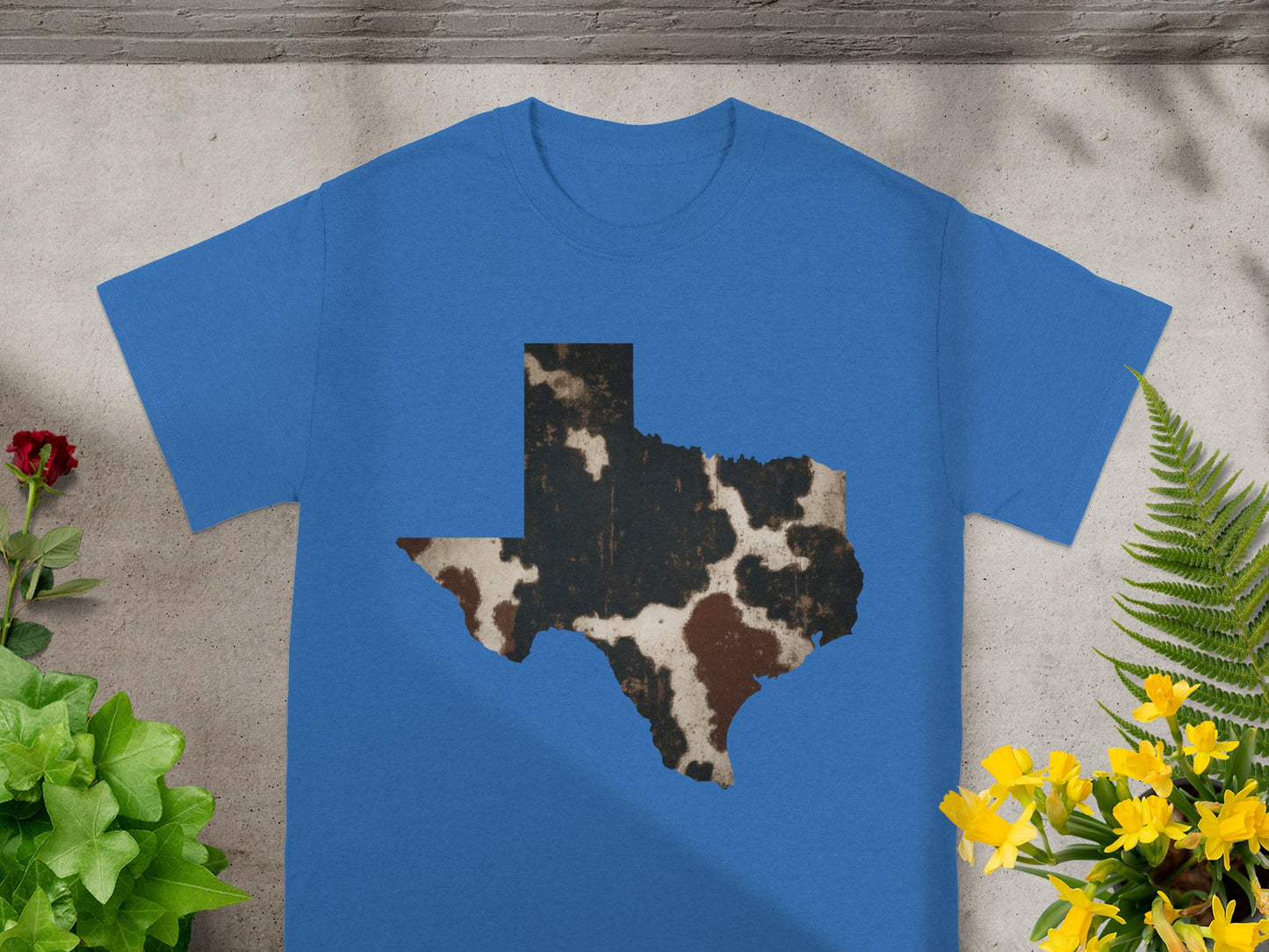 Blue t-shirt with a distressed cowhide pattern in the shape of Texas.