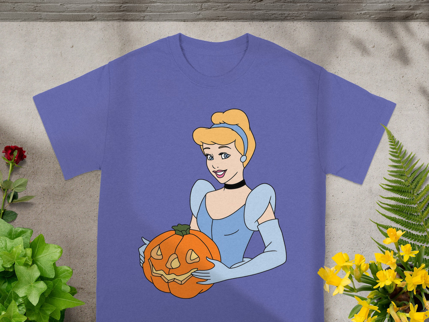 Cinderella wearing a blue gown holds a carved jack-o'-lantern.