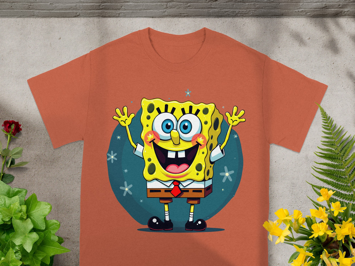 SpongeBob SquarePants cartoon character smiling and waving on a brown t-shirt.