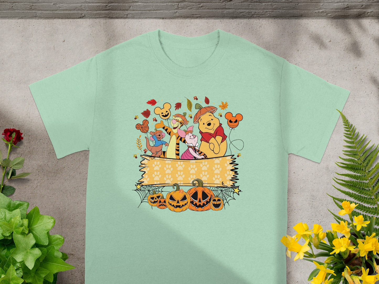 Winnie the Pooh characters with pumpkins, autumn leaves, and Mickey Mouse balloons.