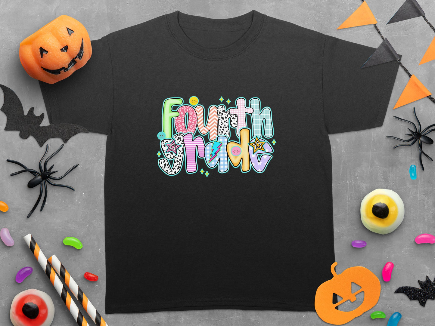 Black t-shirt with colorful "Fourth Grade" text in playful, patterned letters.