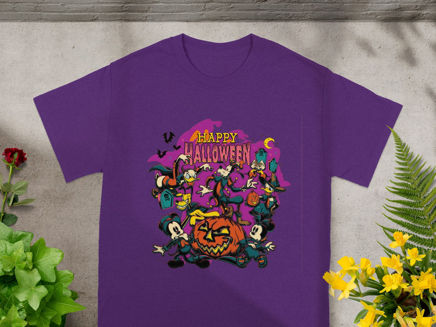 Purple t-shirt with Halloween graphic featuring Mickey Mouse and friends around a jack-o'-lantern.