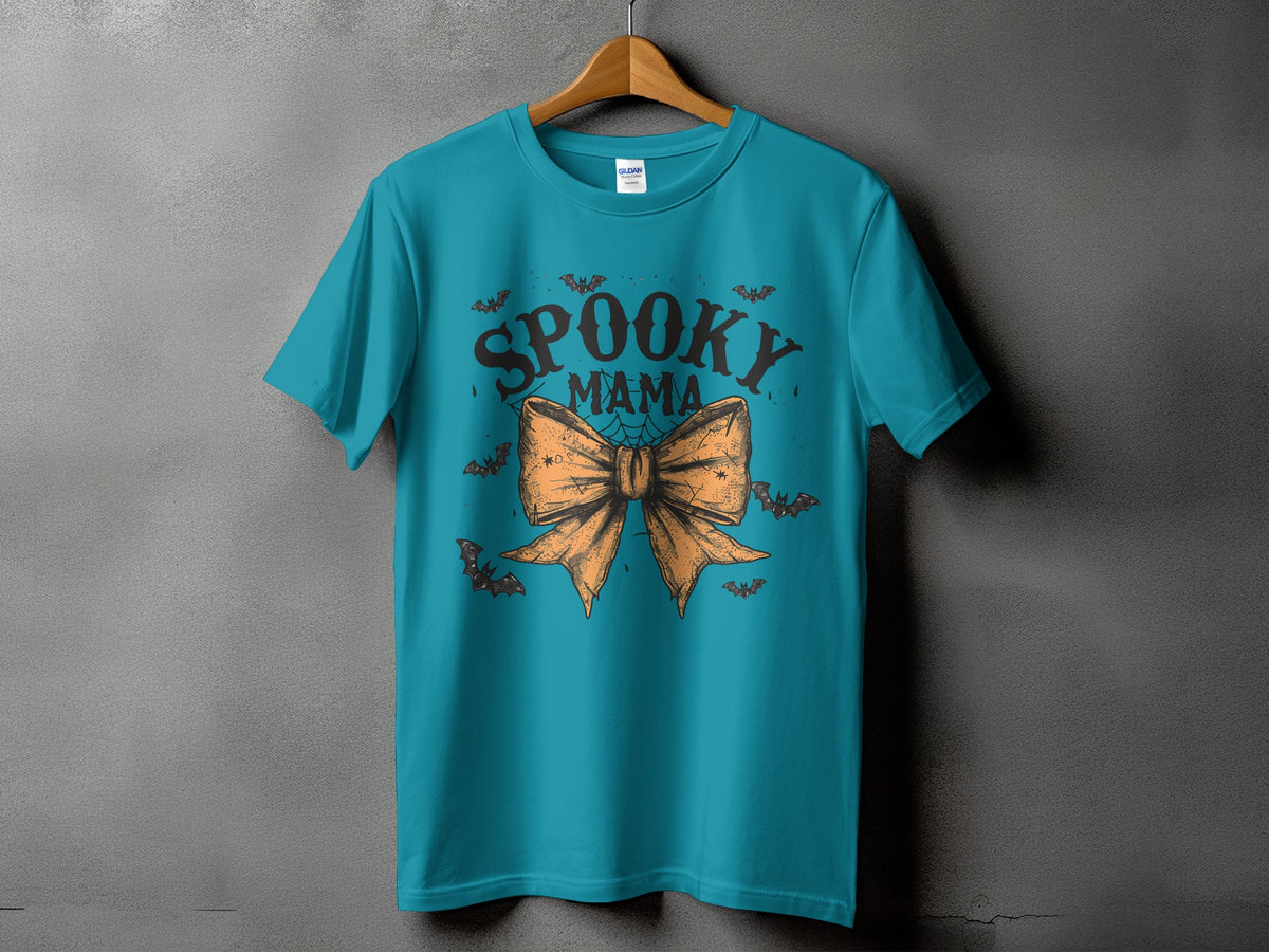 Teal t-shirt with "Spooky Mama" text and an orange bow with bats.