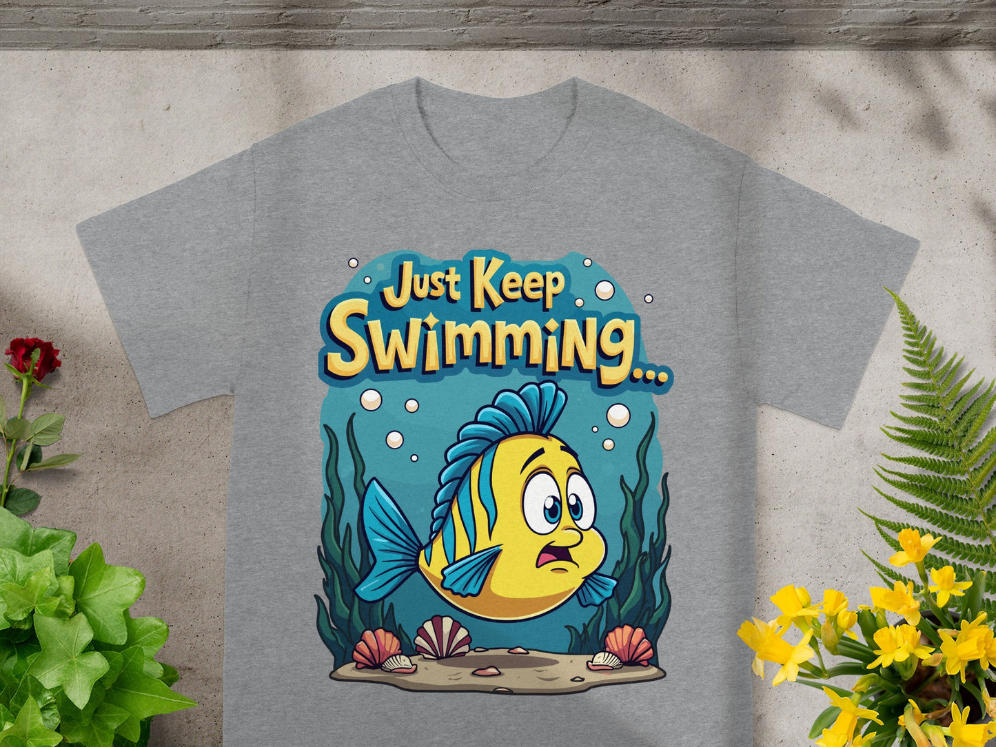 Grey t-shirt with yellow fish and "Just Keep Swimming..." text.