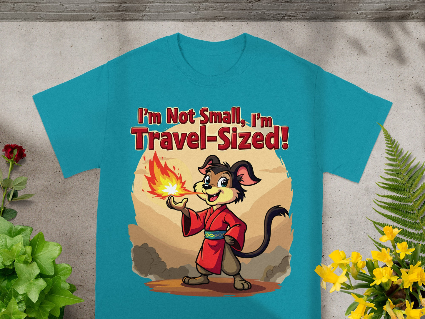 Teal t-shirt with cartoon dog breathing fire and text "I'm Not Small, I'm Travel-Sized!"