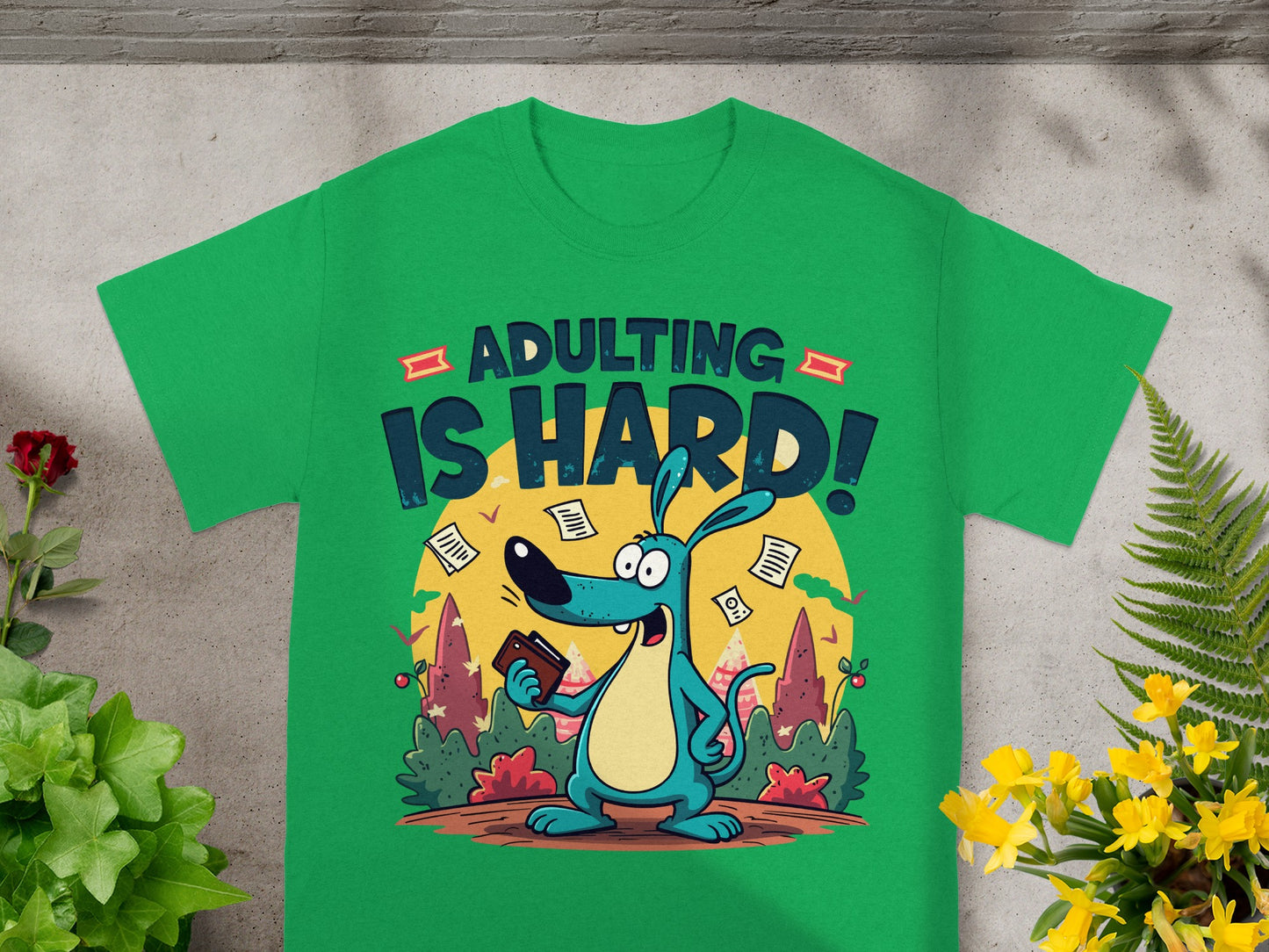 Green t-shirt with cartoon dog and "ADULTING IS HARD!" text.