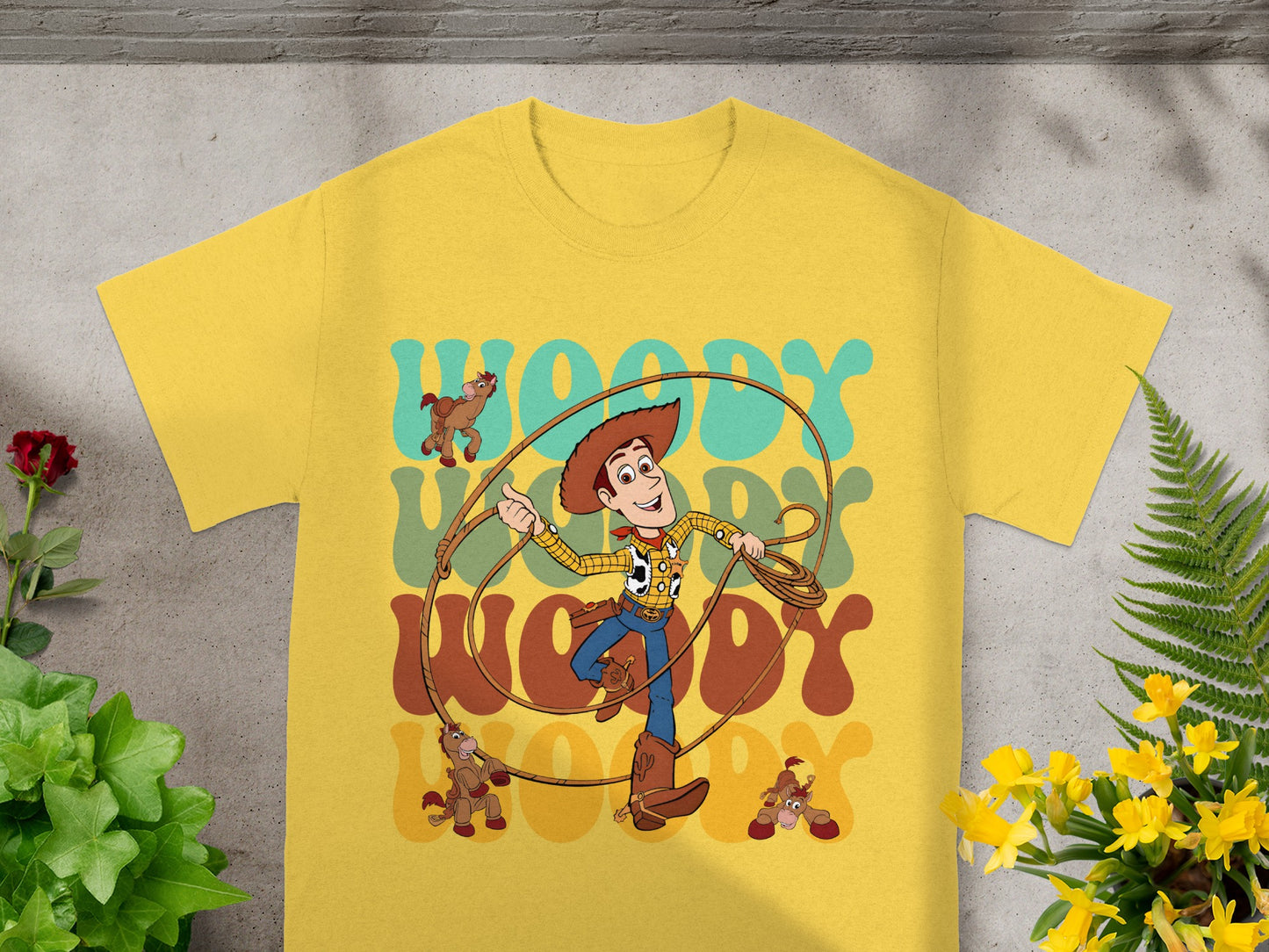Yellow t-shirt with Woody from Toy Story and "WOODY" text.