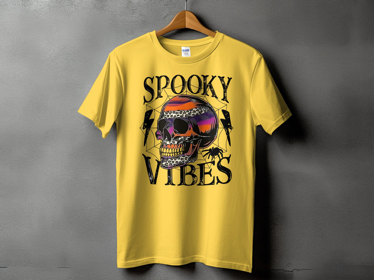 Yellow t-shirt with "Spooky Vibes" text and a colorful skull graphic.