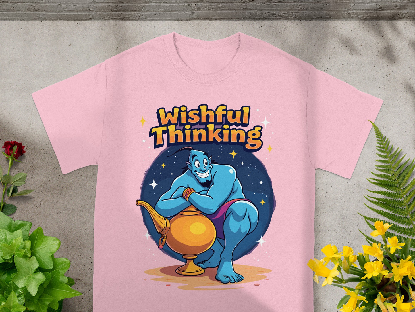 Pink t-shirt featuring a cartoon genie emerging from a golden lamp.