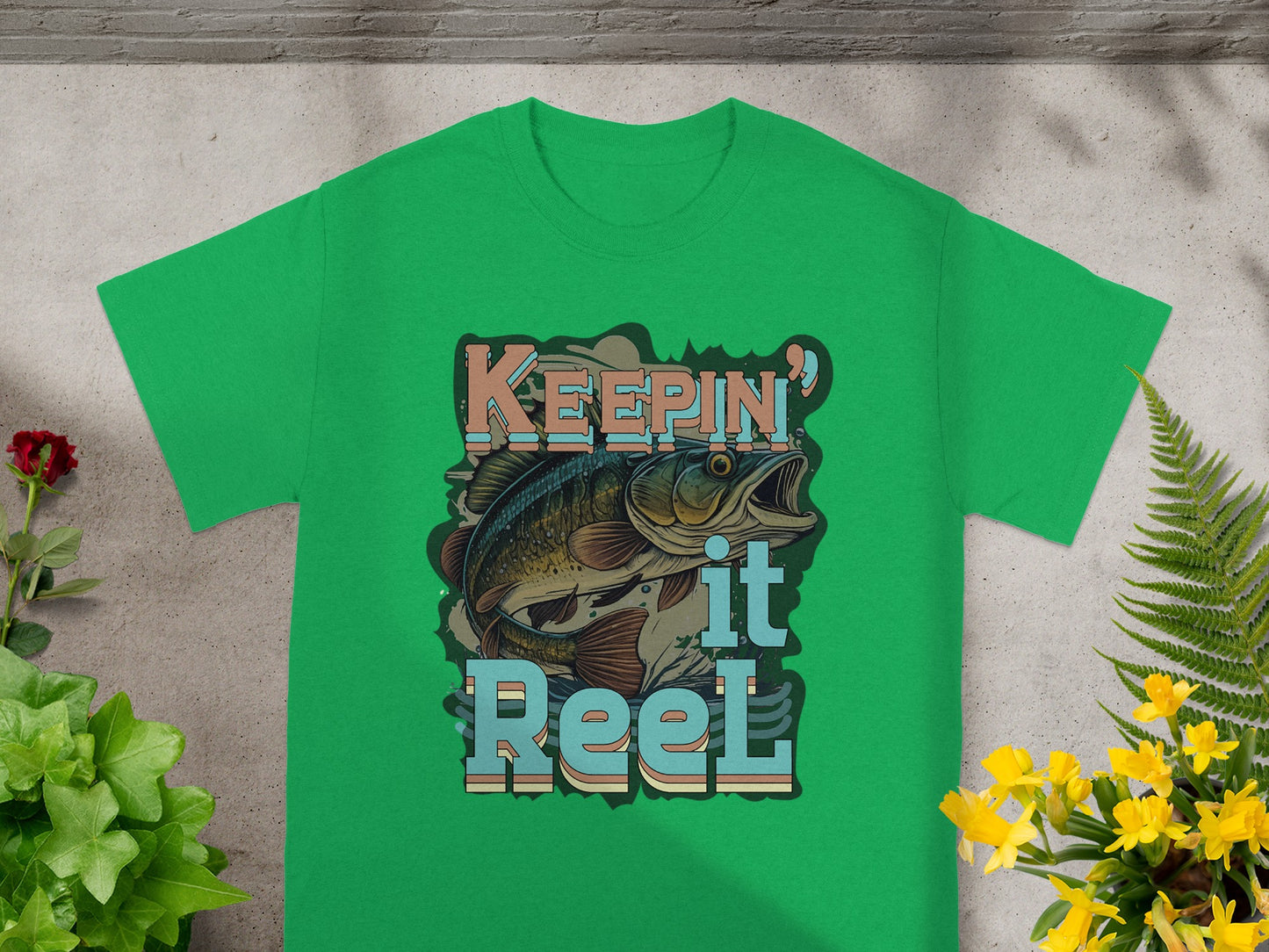 Green t-shirt with "KEEPING it Reel" text and a jumping bass fish graphic.