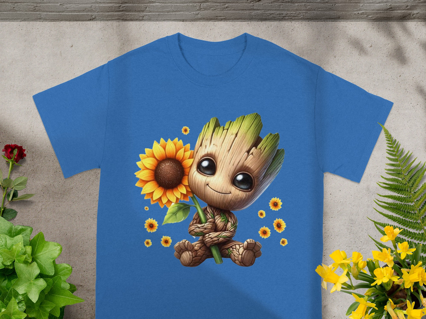 Blue t-shirt with cartoon Groot holding a sunflower and small flowers.