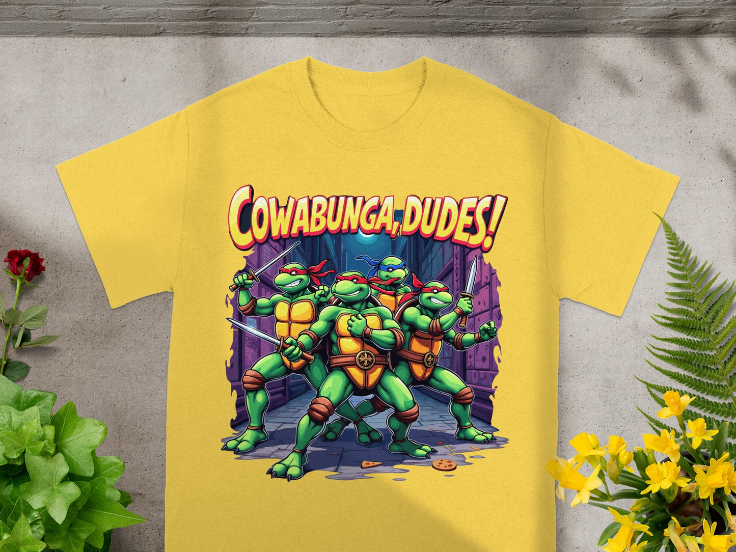 Teenage Mutant Ninja Turtles with "Cowabunga, dudes!" text on a yellow t-shirt.