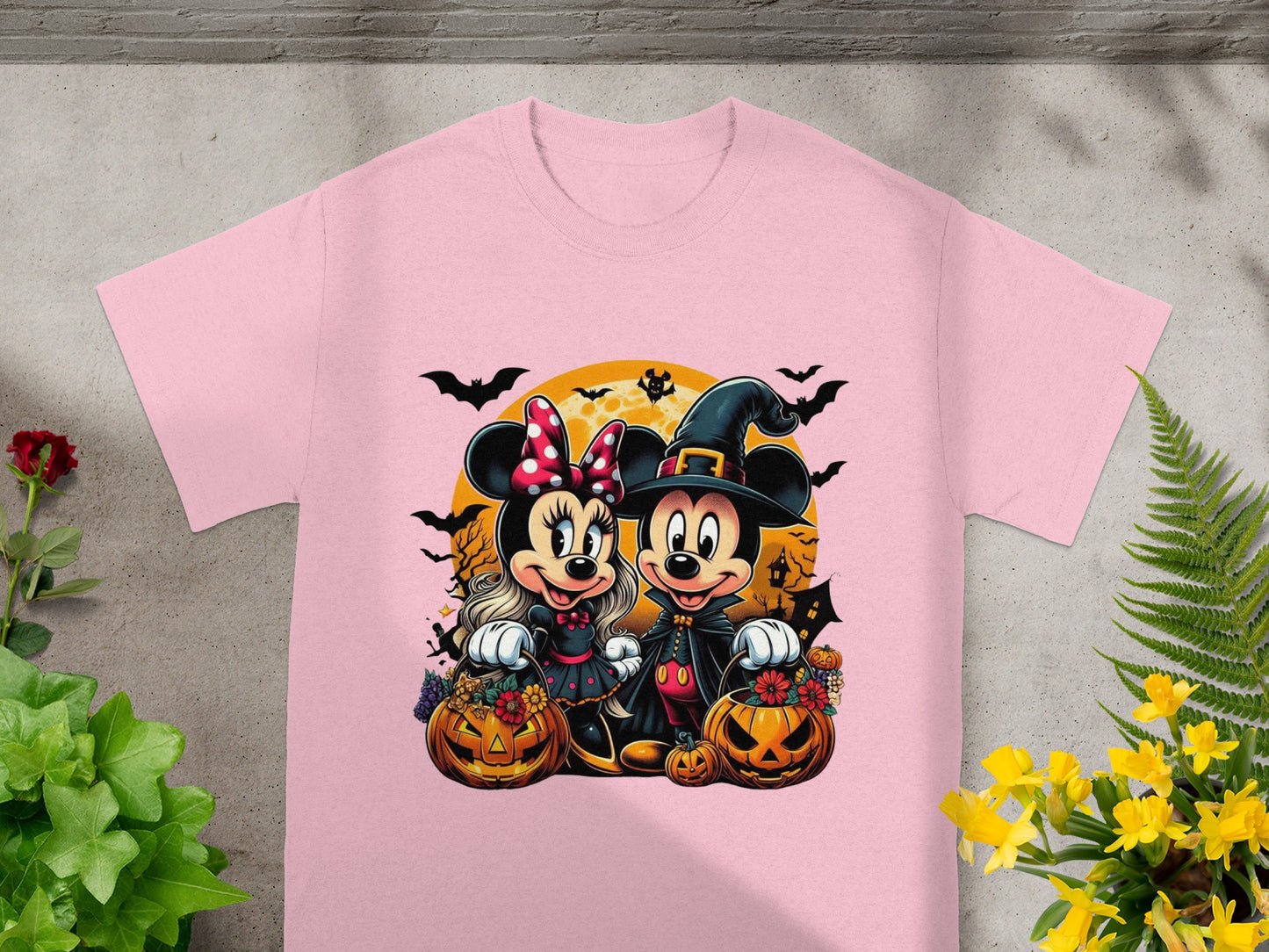 Mickey and Minnie Mouse in Halloween costumes with pumpkins and bats.