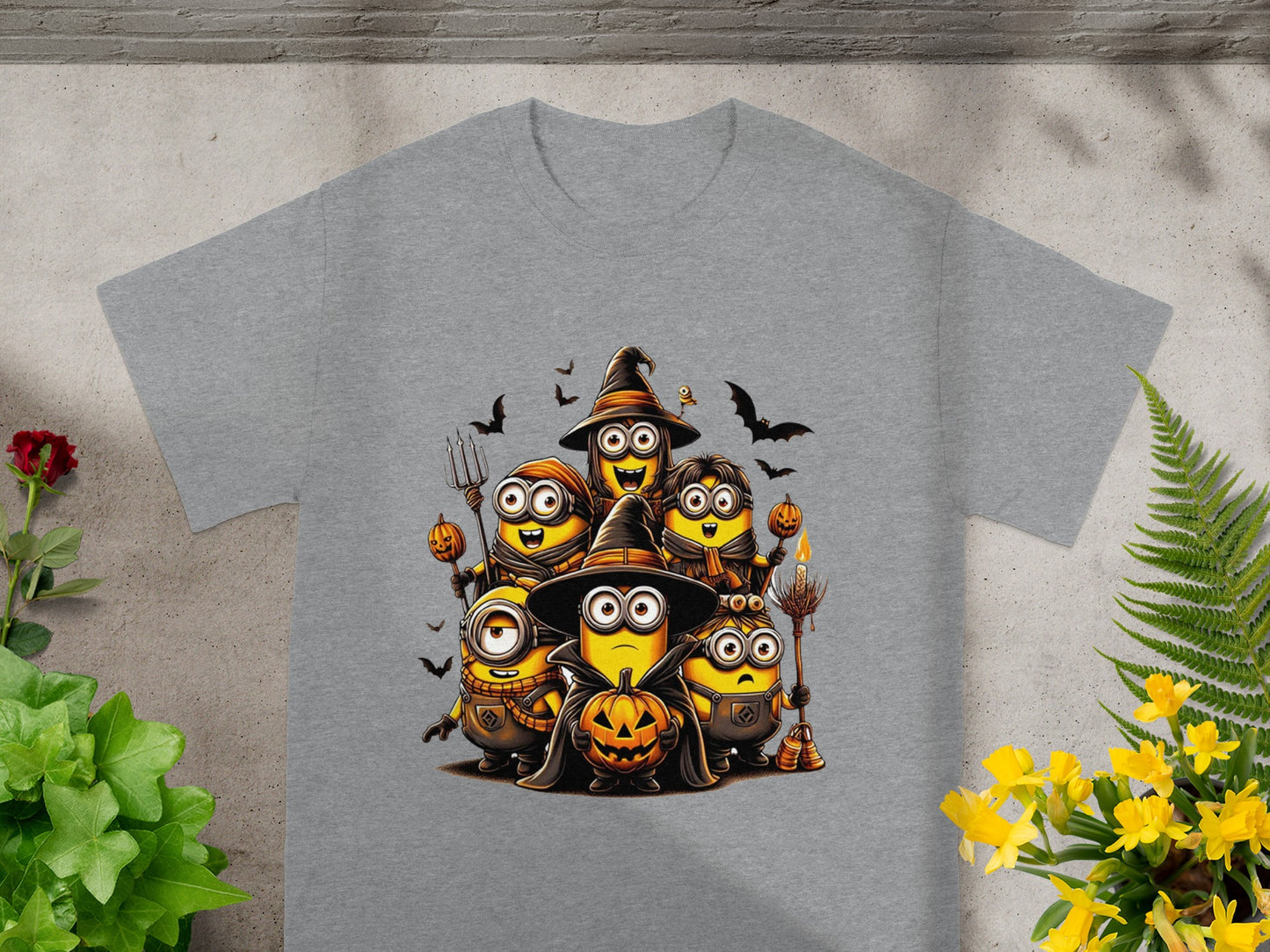 Minions in Halloween costumes with pumpkins and bats on a gray t-shirt.